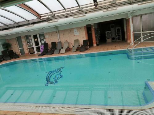 a large swimming pool with a fish painted on it at Delfin Apartman Zalakaros in Zalakaros