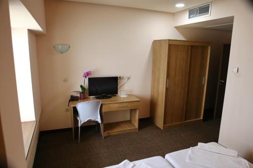 a room with a desk with a computer on it at Hotel Iris in Plovdiv
