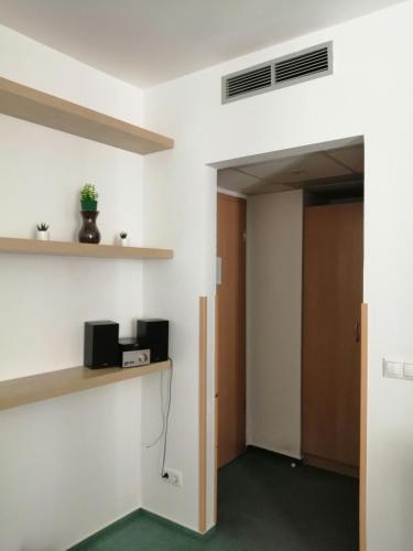 an empty room with a door and a shelf at Delfin Apartman Zalakaros in Zalakaros