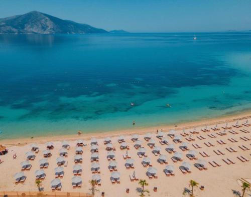 an aerial view of a beach with chairs and umbrellas at Hotel 4Palmat in Orikum