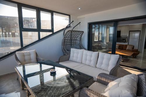a living room with two couches and a table at Sürer Apart Altınkum in Didim