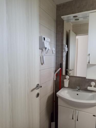 a bathroom with a sink and a mirror at Open Sky Montenegro in Utjeha