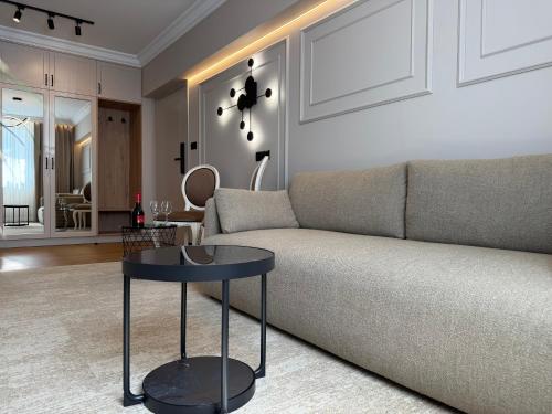 a living room with a couch and a table at Moris Beach Hotel in Gdańsk