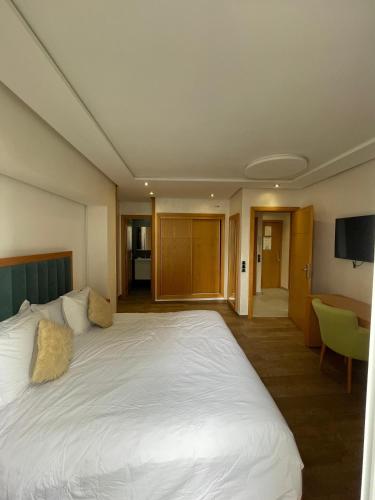a large white bed in a hotel room at Hotel Residence Ramsis in Nador