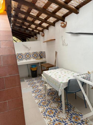 a dining room with a table and chairs and a table and a table and chairs at Il Caimano B & B, con piscina dall'11 Luglio al 31 Agosto in Vulcano