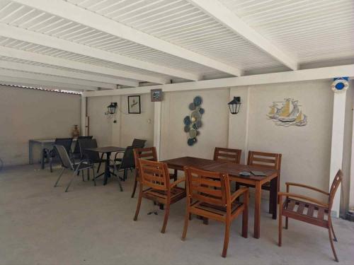 a dining room with wooden tables and chairs at Will House in Mamaia Nord