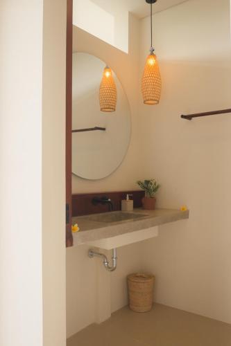 a bathroom with a sink and a mirror at Rasa Ubud Yoga Coliving in Ubud