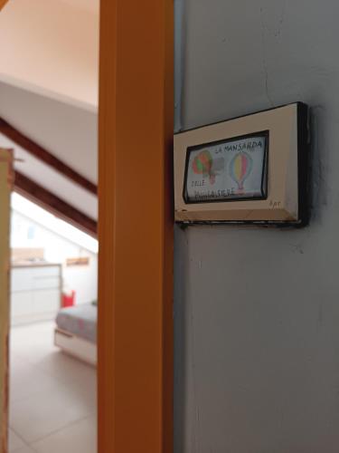 a clock on a wall in a room at La Mansarda delle Mongolfiere in Turin
