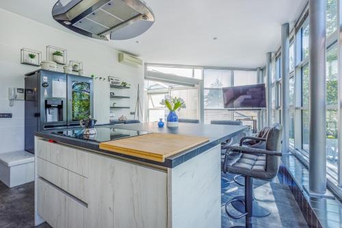 a kitchen with a large island with a counter top at Comics & Cars - Themed Penthouse in Motor Valley in Modena