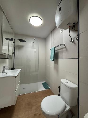 a bathroom with a toilet and a sink and a shower at Sweet Holiday by luca properties grancanaria in Playa del Ingles