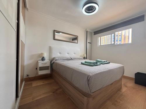 a bedroom with a bed and a window at Sweet Holiday by luca properties grancanaria in Playa del Ingles