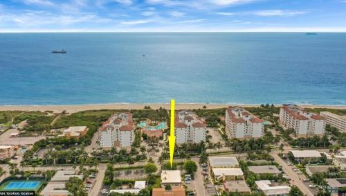 an aerial view of a resort near the ocean at Steps To Beach! 4 Condos In 1- Perfect For Groups in West Palm Beach