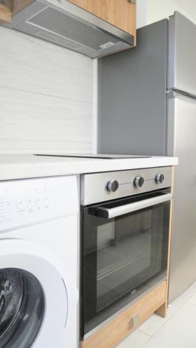 a kitchen with a stove and a refrigerator at KROKOS house 2 in Aliveri