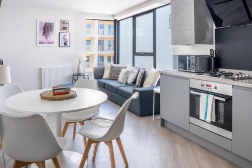 a kitchen and living room with a table and a couch at No Seven Harbour Side in Poole
