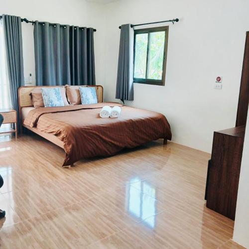 a bedroom with a bed with two towels on it at First Light beach bungalow 1 in Ko Phangan