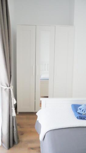 a bedroom with white cabinets and a white bed at KROKOS house 2 in Aliveri