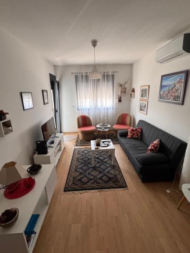 a living room with a couch and a table at Flower and Love Flat Next to centar of podgorica in Podgorica
