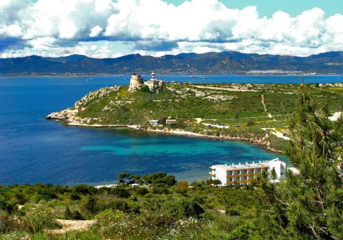 a building on an island in the middle of a body of water at Hotel Calamosca in Cagliari