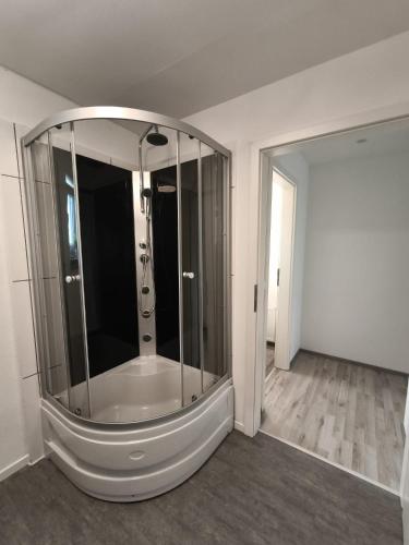 a large glass shower in a white room at Avens in Burgrieden
