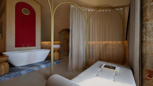 a bathroom with a bath tub and a sink at Mamula Island by Banyan Tree in Herceg-Novi