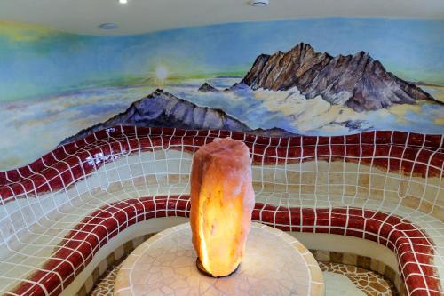 a donut sitting on a table in front of a painting at Hotel-Gasthof Andreas in Obertilliach