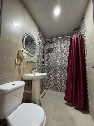 a bathroom with a toilet and a sink and a shower at Karo Hotel in K'obulet'i