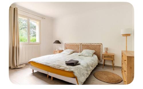 a bedroom with a bed and a window at Hôtel Thiron Gardais in Thiron-Gardais