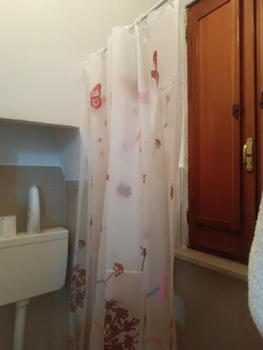 a bathroom with a shower curtain with butterflies on it at PROF OLIVETO ANTICo in San Marco in Lamis