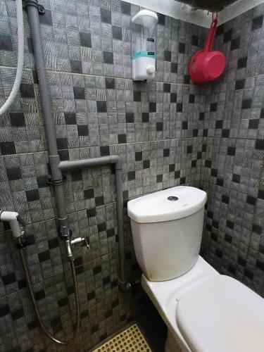 a bathroom with a toilet and a shower at Cassa Bonda Std Triple Room in Machang