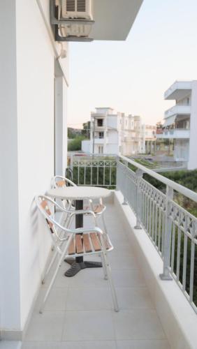a chair sitting on the balcony of a building at KROKOS house 2 in Aliveri