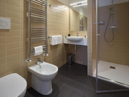 a bathroom with a toilet and a sink and a shower at Portica Homes Assisi in Assisi