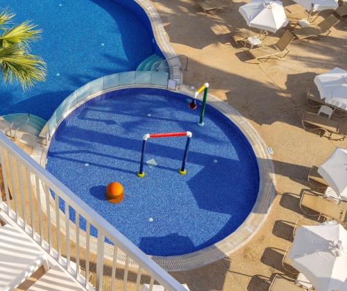 an overhead view of a swimming pool with an orange in it at Papantonia Hotel in Protaras