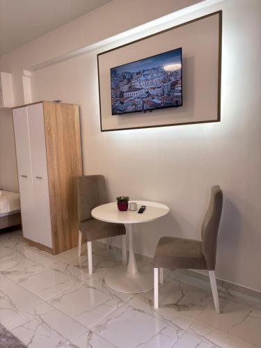 a dining room with a table and two chairs at SM studio apartman in Banja Luka