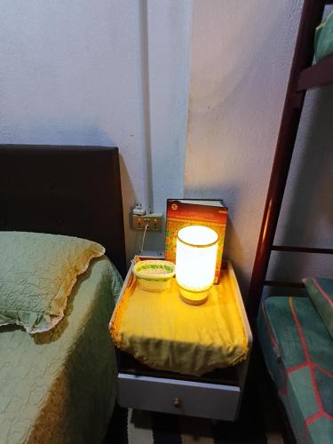 a table with a bowl on it next to a bed at Cassa Bonda Std Triple Room in Machang