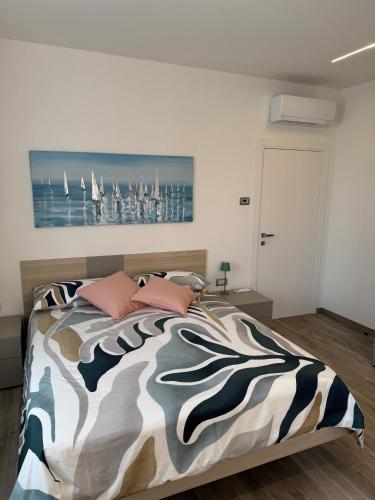 a bedroom with a bed with a painting on the wall at B&B Ersilia in Eupilio