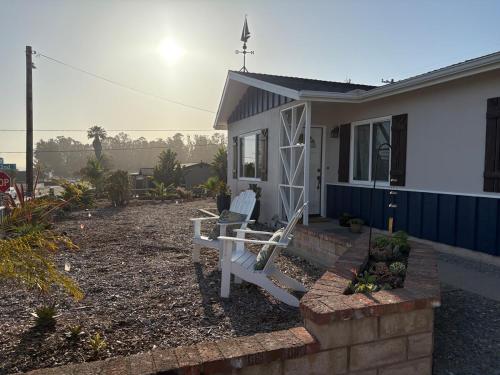 a house with a bench in front of it at Seaside Garden Escape, A Stroll to the Beach! in Grover Beach