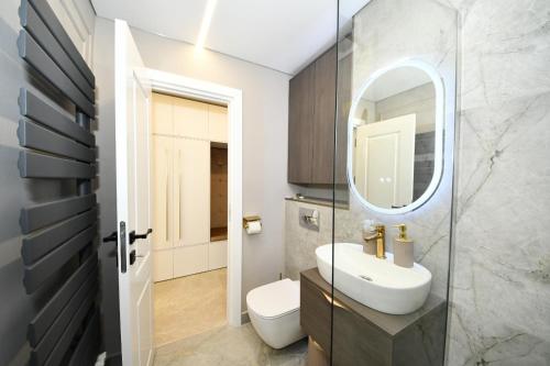 a bathroom with a sink and a mirror at VS Gold Apartament in Galaţi