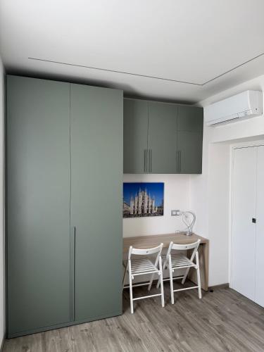 a kitchen with a table and two chairs at B&B Ersilia in Eupilio