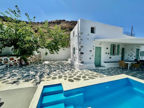 a villa with a swimming pool and a house at Siesta Villas Cycladic Elegance with Castle View in Livadi Astypalaias