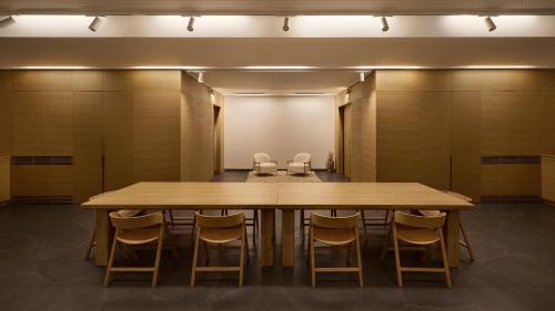a conference room with a large wooden table and chairs at Mamula Island by Banyan Tree in Herceg-Novi