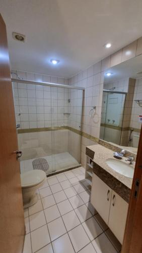 a bathroom with a shower and a toilet and a sink at ApartHotel no Centro de Brasília in Brasilia