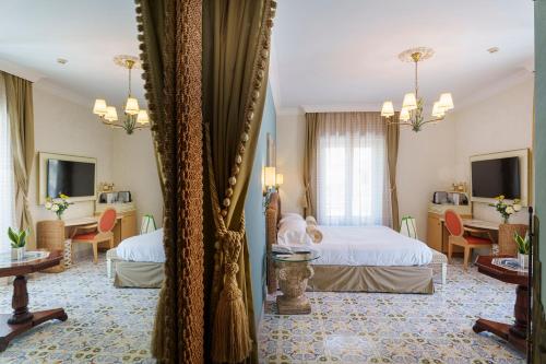 a hotel room with two beds and a mirror at Manzi Hotel & Spa in Ischia
