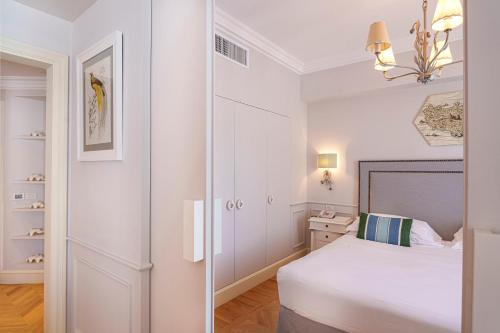 a white bedroom with a bed and a closet at Manzi Hotel & Spa in Ischia