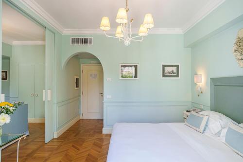 a bedroom with a bed and a chandelier at Manzi Hotel & Spa in Ischia