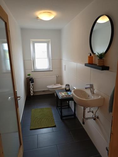 a bathroom with two sinks and a mirror at Lodge Ehrenberg in Ehenbichl
