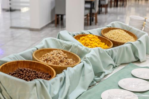 three bowls filled with different types of food on a table at Papantonia Hotel in Protaras