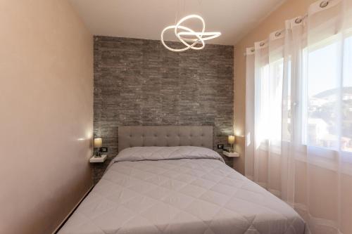 Postel nebo postele na pokoji v ubytování B&B Il Glicine