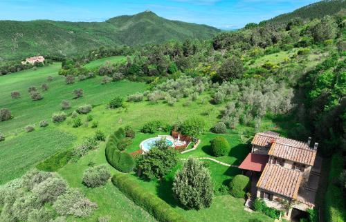 an aerial view of a house in a green field at Villa Toscana in Montecastelli Pisano
