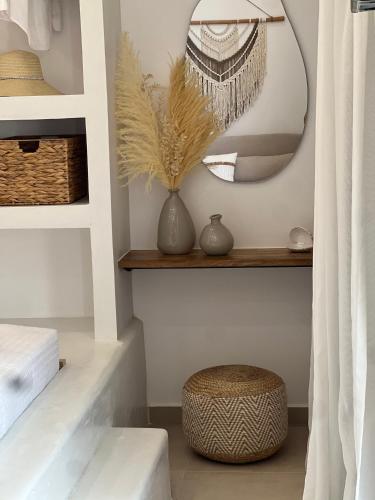 a dressing room with a mirror and a stool at Patela Luxury Suites in Panormos Kalymnos