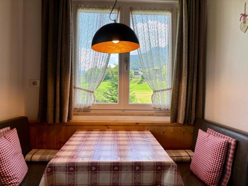 a room with a table in front of a window at Residence Linde - Ferienwohnungen & Apartments in Castelrotto